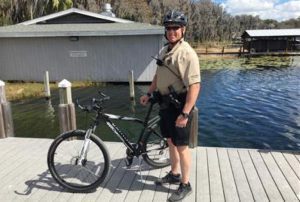 Police officer standing next to bike